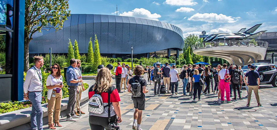 Visitors gather outside the Avengers Campus building at Disneyland Paris under clear skies.
